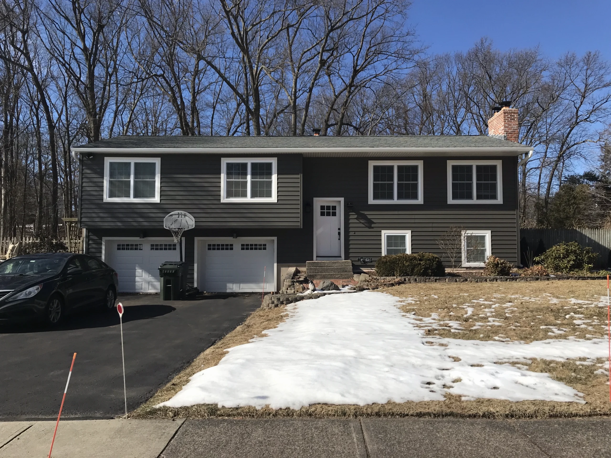 Gray, modern house with window, door, roof, vinyl siding and garage door replacement in CT by Sensible Home Products